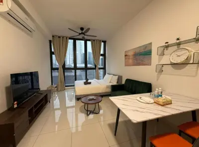 a living room with a couch and a bed and a television at The Majestic Residence KLCC By Castle in Kuala Lumpur