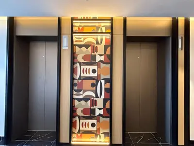 two elevators in a building with a patterned wall at The Majestic Residence KLCC By Castle in Kuala Lumpur