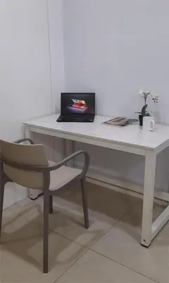 a laptop computer sitting on a white desk with a chair at Kuala Lumpur Mont Kiara Arcoris SOHO 5 Pax, Walk to Mall, Pool, WIFI in Kuala Lumpur