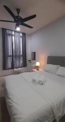 a bedroom with a white bed with a ceiling fan at Kuala Lumpur Mont Kiara Arcoris SOHO 5 Pax, Walk to Mall, Pool, WIFI in Kuala Lumpur