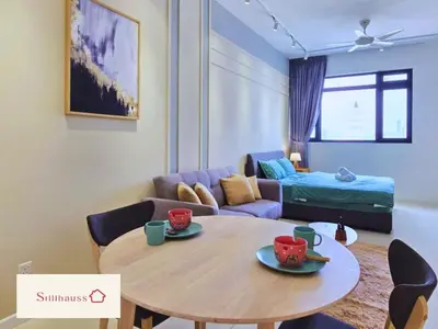 a living room with a table and a couch at KLCC View Walk to PWTC & Sunway Putra 3 Pax in Kuala Lumpur