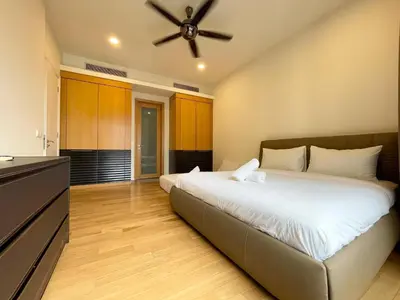 a bedroom with a large bed with a ceiling fan at St Mary Residence by PILLOWTALKS in Kuala Lumpur
