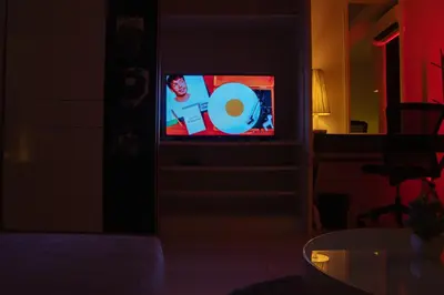 a tv with a cd on it in a dark room at KL Hartamas Studio, Wifi Smart TV in Kuala Lumpur