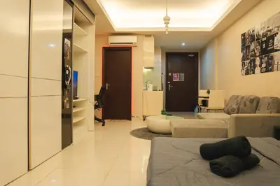 a large living room with a couch and a living room with at KL Hartamas Studio, Wifi Smart TV in Kuala Lumpur