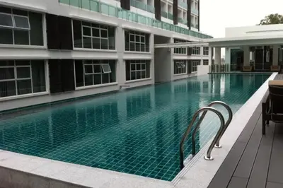 a swimming pool in front of a building at KL Hartamas Studio, Wifi Smart TV in Kuala Lumpur