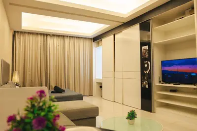 a living room with a couch and a tv at KL Hartamas Studio, Wifi Smart TV in Kuala Lumpur