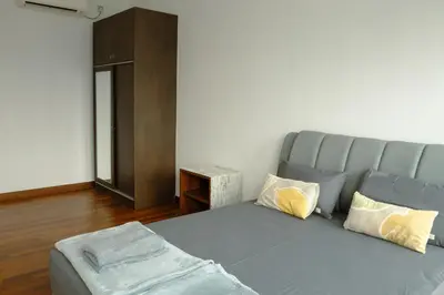 a bed in a room with a couch and a table at KL Luxury Residence 3BR Golden Triangle in Kuala Lumpur