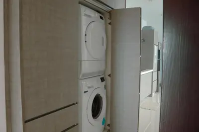 a bathroom with a washing machine and a washer at KL Luxury Residence 3BR Golden Triangle in Kuala Lumpur