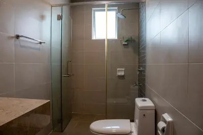 a bathroom with a toilet and a glass shower at KL Luxury Residence 3BR Golden Triangle in Kuala Lumpur