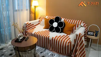 a living room with a couch with a flower on it at KLCC 23A Premium 1B1R with Best View Infinity Pool and Netflix 1080HD in Kuala Lumpur