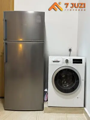 a refrigerator and a washing machine in a room at KLCC 23A Premium 1B1R with Best View Infinity Pool and Netflix 1080HD in Kuala Lumpur