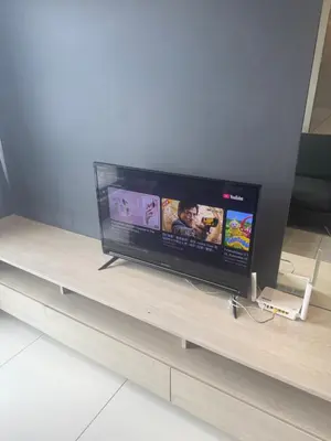 a flat screen tv sitting on top of a table at ROBERTSON RESIDENCE KUALA LUMPUR By IKNAS SUITES in Kuala Lumpur