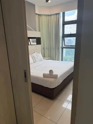 a bed in a room with a window at ROBERTSON RESIDENCE KUALA LUMPUR By IKNAS SUITES in Kuala Lumpur