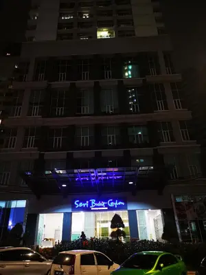 a building with a sign in front of it at night at Seri Bukit Ceylon Kuala Lumpur in Kuala Lumpur