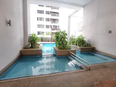 an indoor pool in a building with potted plants at Seri Bukit Ceylon Kuala Lumpur in Kuala Lumpur