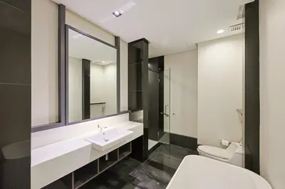 a bathroom with a sink and a toilet at The Mews KLCC Home Plus in Kuala Lumpur