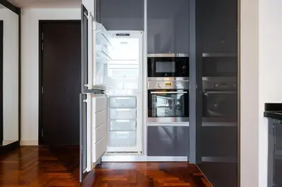 an open refrigerator with its door open in a kitchen at The Mews KLCC Home Plus in Kuala Lumpur