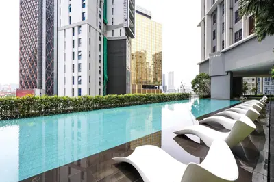 a swimming pool in the middle of a city with tall buildings at The Mews KLCC Home Plus in Kuala Lumpur