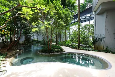 a pool in the middle of a courtyard with trees at The Mews KLCC Home Plus in Kuala Lumpur