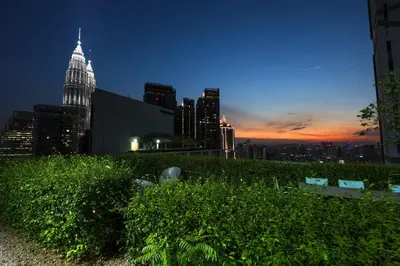 a city skyline at night with a tall building at The Mews KLCC Home Plus in Kuala Lumpur