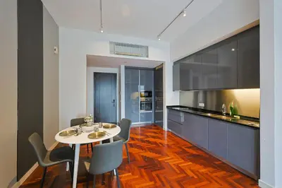 a kitchen with a table and chairs in a room at The Mews KLCC Home Plus in Kuala Lumpur