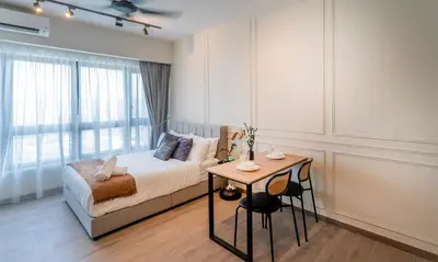 a bedroom with a bed and a table and a window at Agile Bukit Bintang TRX KL City by Cobnb in Kuala Lumpur