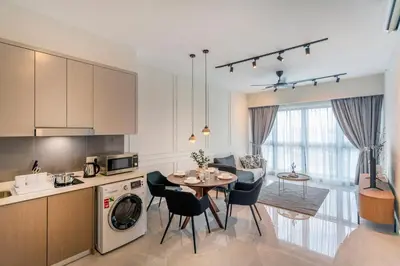 a kitchen and living room with a table and chairs at Agile Bukit Bintang TRX KL City by Cobnb in Kuala Lumpur