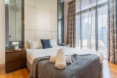 a bedroom with a bed and a large window at Dorsett Bukit Bintang near Pavilion KL, Kuala Lumpur in Kuala Lumpur