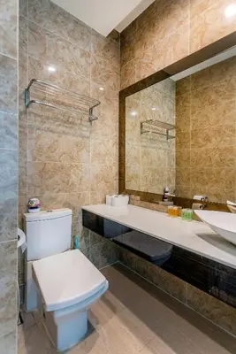 a bathroom with a toilet and a sink and a mirror at Dorsett Bukit Bintang near Pavilion KL, Kuala Lumpur in Kuala Lumpur