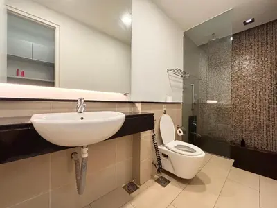 a bathroom with a sink and a toilet at Swiss Garden Residence by PILLOWTALKS in Kuala Lumpur
