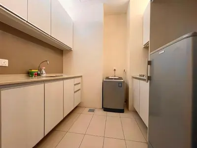 a kitchen with white cabinets and a refrigerator at Swiss Garden Residence by PILLOWTALKS in Kuala Lumpur