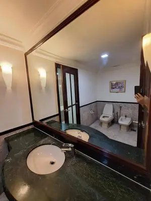 a bathroom with a sink and a toilet and a mirror at Times Square Service Apartment , Kuala Lumpur in Kuala Lumpur