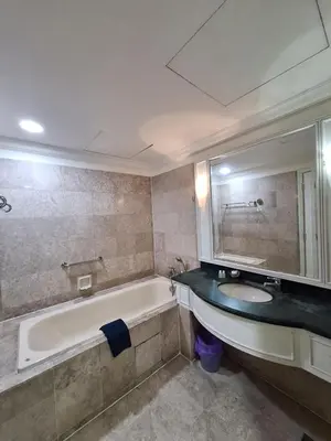 a bathroom with a tub and a sink and a mirror at Midtown Suite At Times Square Hotel KL in Kuala Lumpur