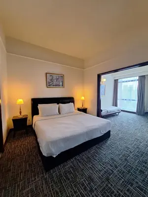 a bedroom with a large bed and a large window at Midtown Suite At Times Square Hotel KL in Kuala Lumpur