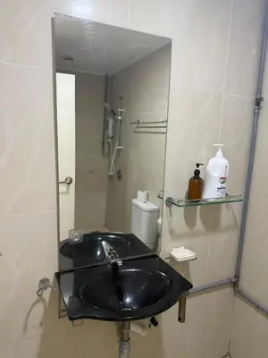a bathroom with a sink and a mirror at PARKVIEW RESIDENCE KLCC By IKNAS SUITES in Kuala Lumpur