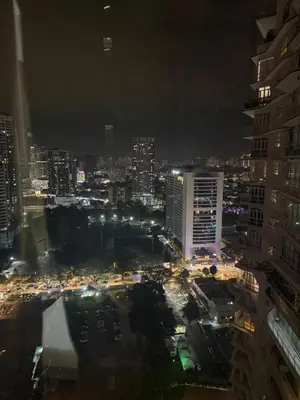 a city lit up at night with traffic at PARKVIEW RESIDENCE KLCC By IKNAS SUITES in Kuala Lumpur