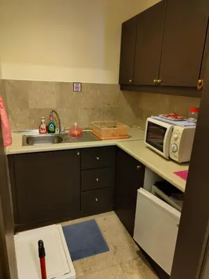 a kitchen with a sink and a microwave at Visitor Suites At Times Square Kuala Lumpur in Kuala Lumpur