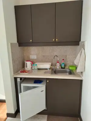 a small kitchen with a sink and a counter at BBS Suites At Times Square in Kuala Lumpur