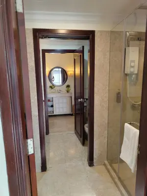 a bathroom with a walk in shower and a mirror at BBS Suites At Times Square in Kuala Lumpur