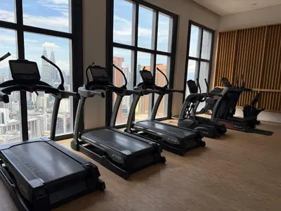 a group of exercise bikes in a room with windows at Lucentia Infinity Pool Suit Kuala Lumpur in Kuala Lumpur