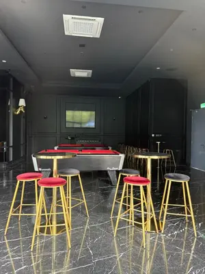 a room with a pool table and four bar stools at Star Residences One klcc in Kuala Lumpur
