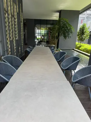 a long table in a room with chairs at Star Residences One klcc in Kuala Lumpur