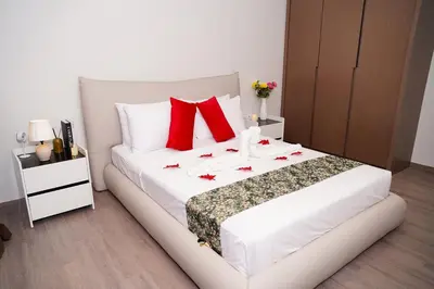 a bedroom with a large white bed with red pillows at Agile Kuala Lumpur City Centre By AMG in Kuala Lumpur