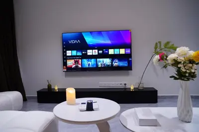 a living room with a tv and a white couch at Agile Kuala Lumpur City Centre By AMG in Kuala Lumpur