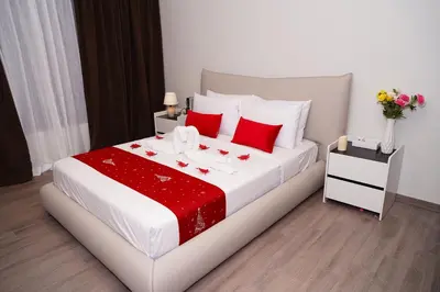 a bedroom with a large white bed with red pillows at Agile Kuala Lumpur City Centre By AMG in Kuala Lumpur