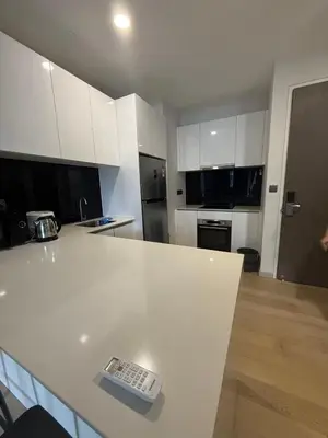 a kitchen with white cabinets and a white counter top at Star Residences One KLCC in Kuala Lumpur