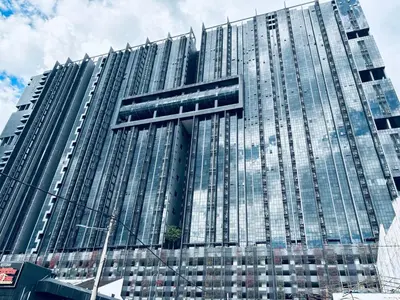 a tall glass building with a lot of windows at Garden Balcony 2BR Home with Great Facilities and Parking in Kuala Lumpur