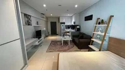 a living room with a couch and a table at Summer Suites KLCC in Kuala Lumpur