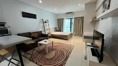 a living room with a couch and a table at Summer Suites KLCC in Kuala Lumpur