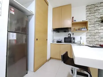 a small kitchen with a counter and a refrigerator at KL studio with Private Jacuzzi in Kuala Lumpur
